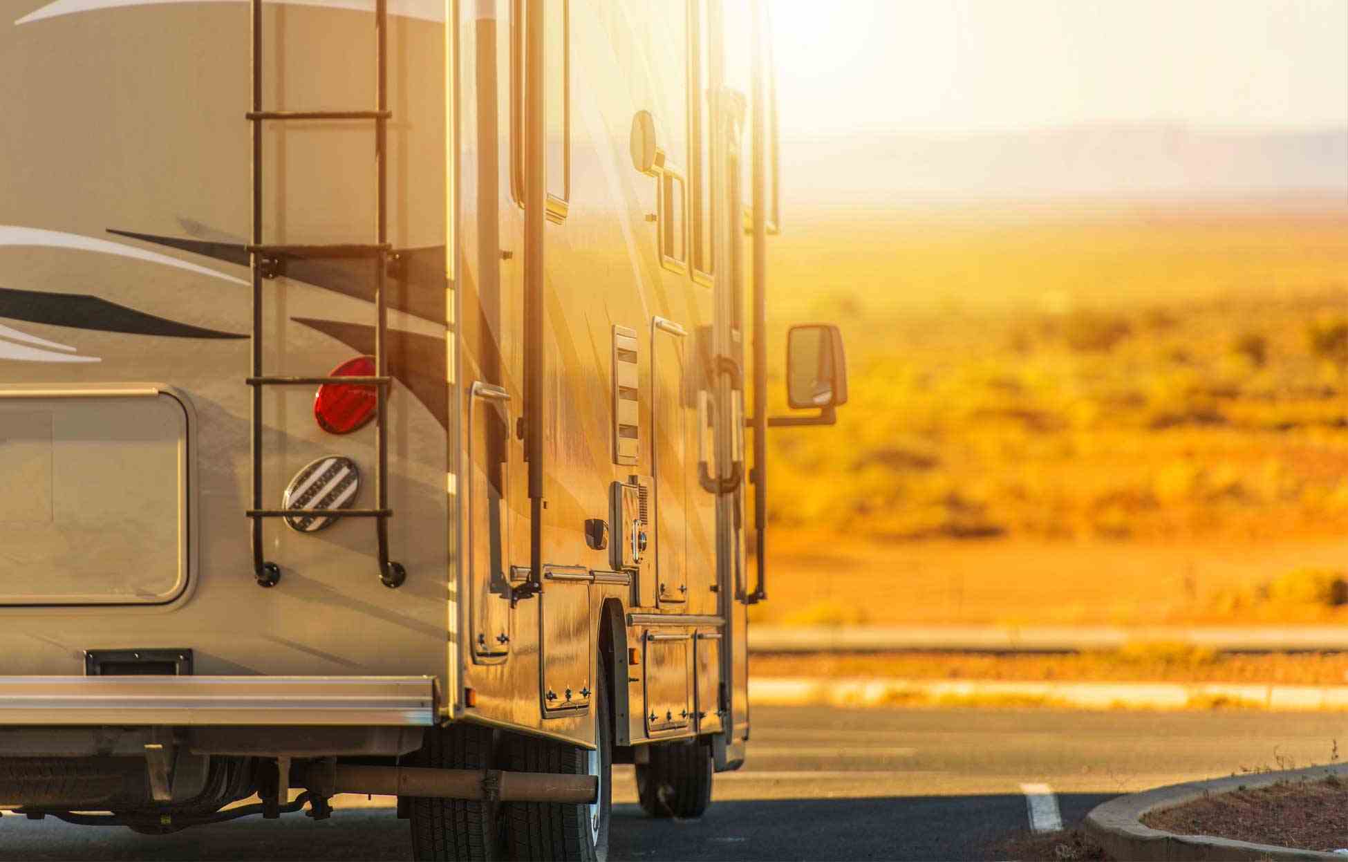 Motorhome at Sunset Motorhome traveling along a highway during sunset.