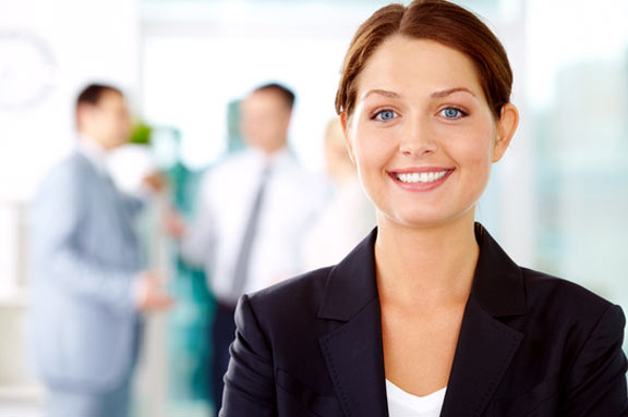 Business professional smiling in an office environment.